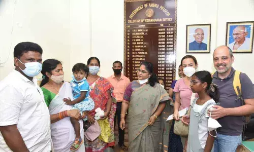 District collector A Surya Kumari handing over the girlchild to Spanish couple