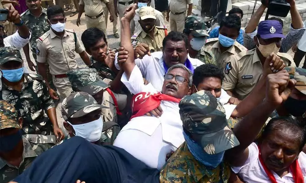 Police taking CPM State Executive Member Ch Babu Rao and other leaders into custody at CRDA office in Tulluru on Monday
