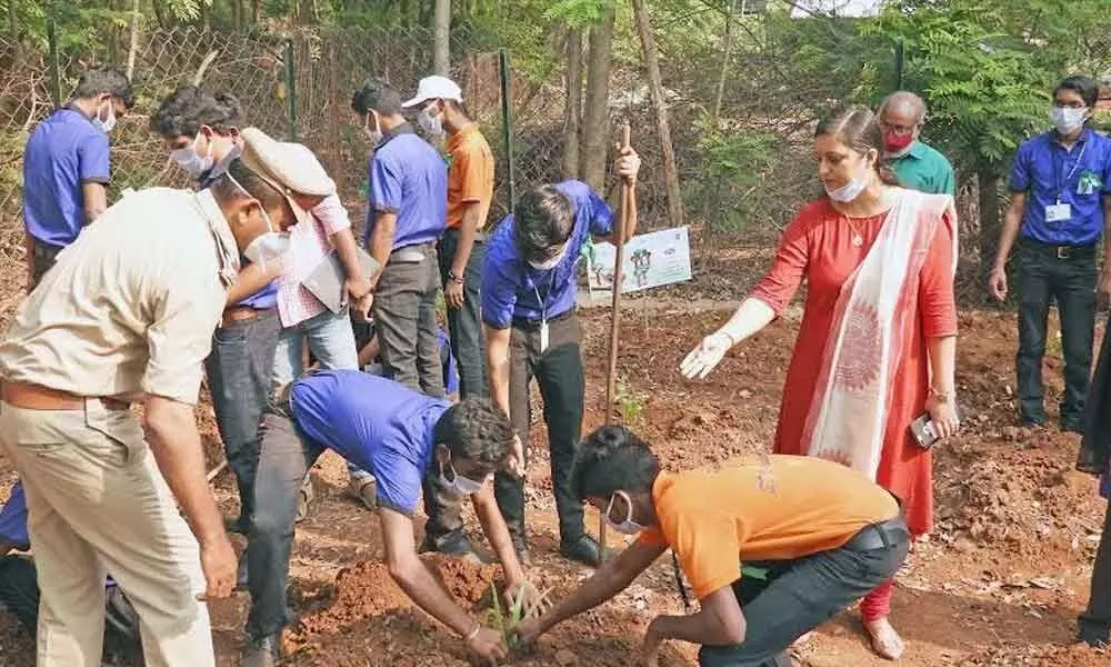 Students of SDI along with zoo officials taking part in the tree plantation programme at IGZP in Visakhapatnam on Monday