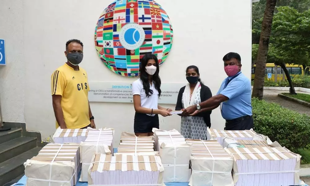 CIS girl donates 750 repurposed notebooks to underprivileged students