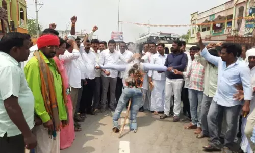 Tribal leaders burning an effigy of the Central government in Nalgonda on Wednesday