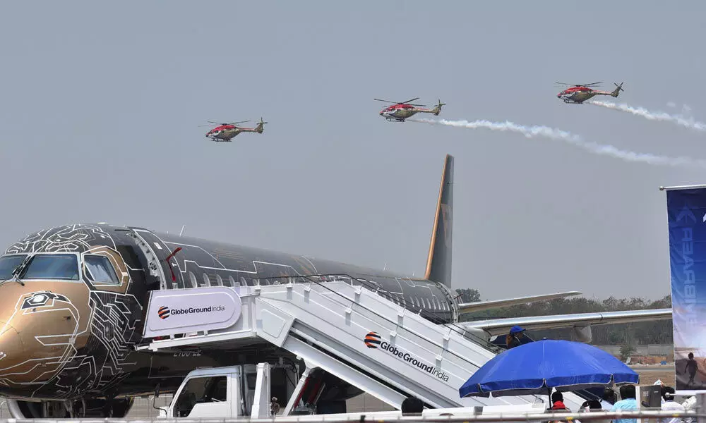 IAFs Sarang helicopter team performs a flypast on the first day of Wings India-2022 at the Begumpet Airport in Hyderabad on Thursday.  Photo: Adula Krishna