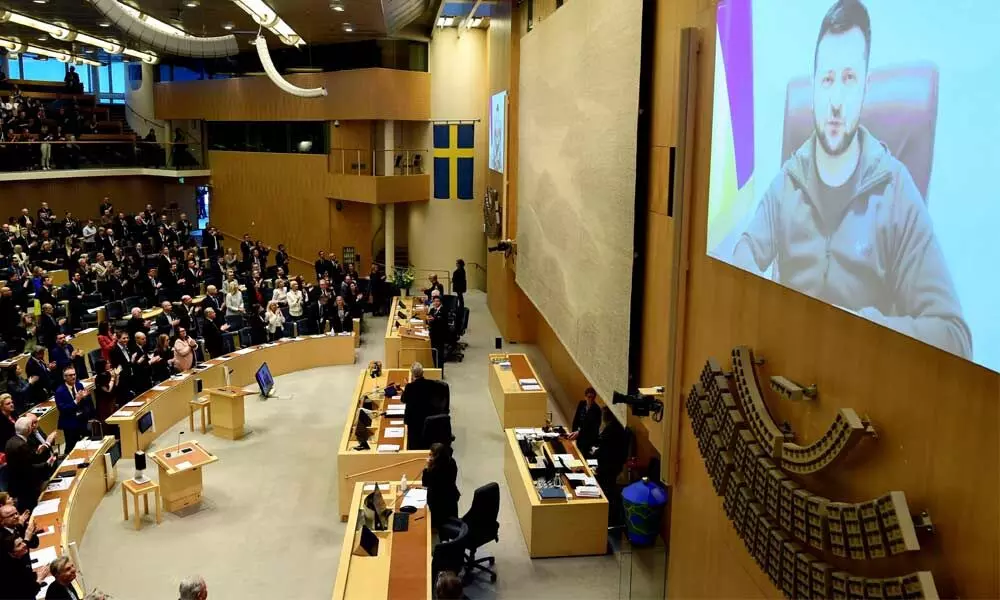 Ukraines President Volodymyr Zelenskyy receives a standing ovation as he addresses the Swedens parliament via video link, in Stockholm on Thursday