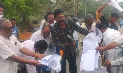 Protesters burning an image of the Union Steel Minister as a part of the dharna staged in Visakhapatnam on Thursday