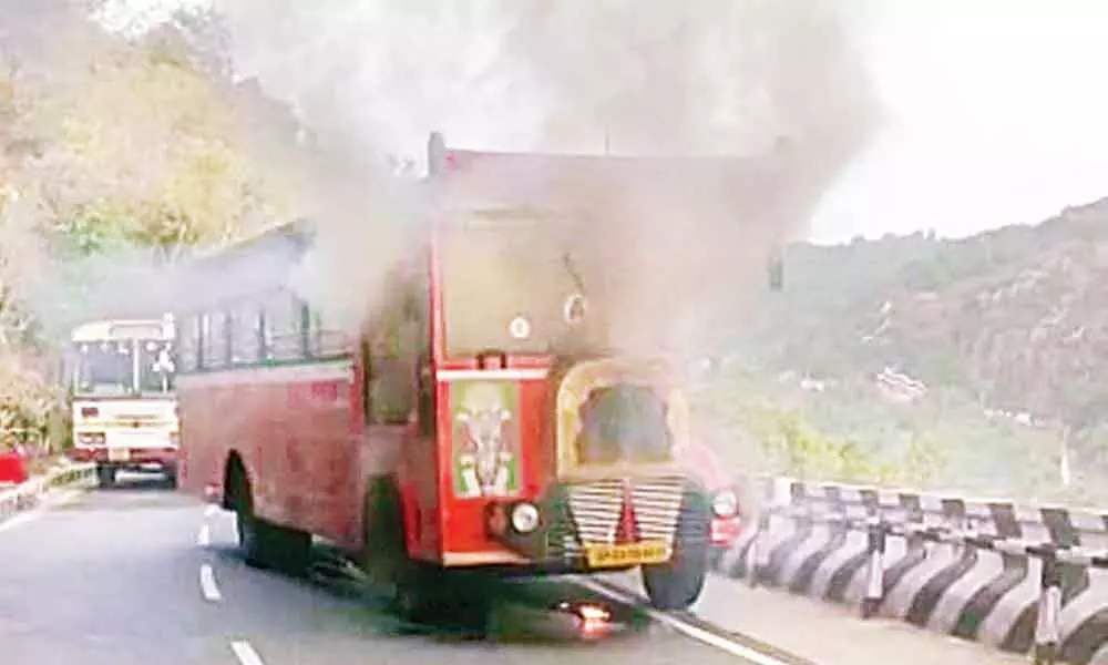 Smoke billows from the TTD free service bus on second ghat road at Tirumala on Saturday