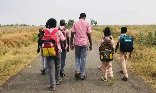 Students walking to the government higher secondary school from Kurumbapalayam in Perambalur district