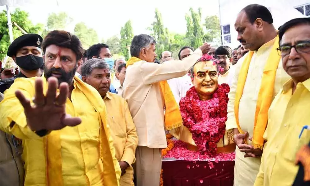 TDP chief N Chanrababu Naidu, MlA N  Balakrishna and other leaders pay floral tributes to statue of party founder N T  Rama Rao at New MLA Quarters in Hyderabad where NTR founded the party 40 years ago
