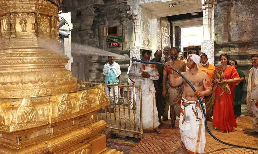 TTD addl EO  A V Dharma Reddy cleaning the Dwajasthambham in Tirumala temple on the occasion of Koil Alwar Tirumanjanam held in the shrine on Tuesday
