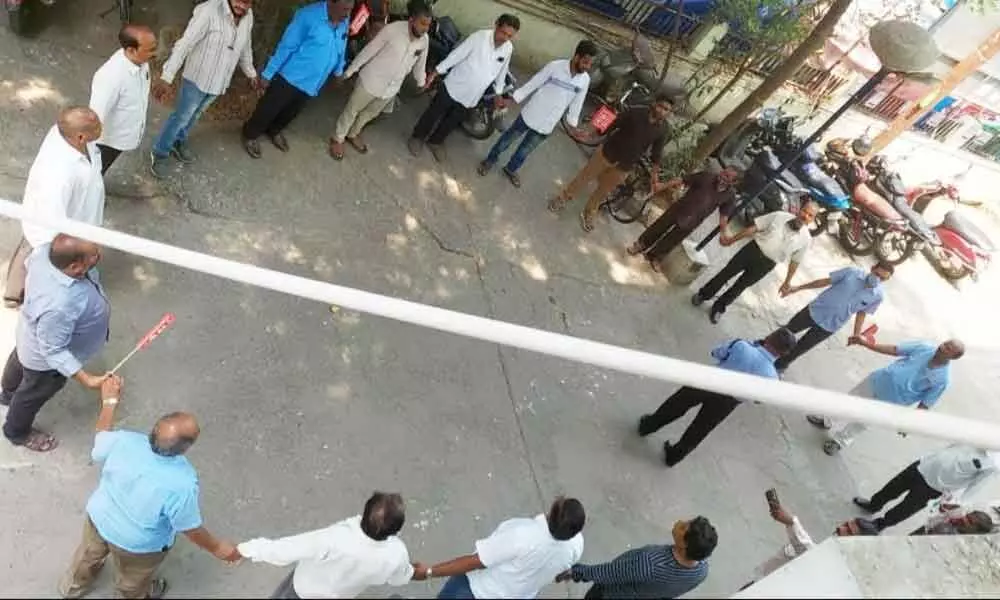 LIC staff forming a human chain in front of CB-1 branch office in Vijayawada on Tuesday