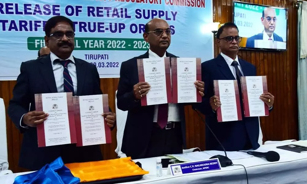 APERC chairman Justice C V Nagarjuna Reddy (centre) and other members releasing the new tariff order for power consumers in Tirupati on Wednesday