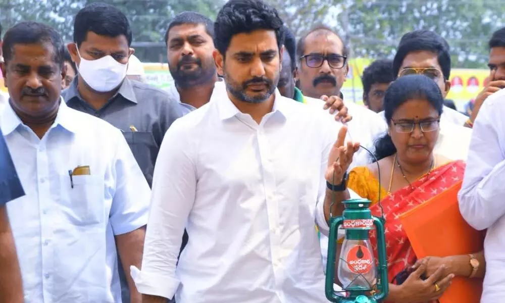 TDP national general secretary Nara Lokesh arrives at party NTR Bhavan in Mangalagiri holding a lantern in protest against increase in power tariff, on Thursday