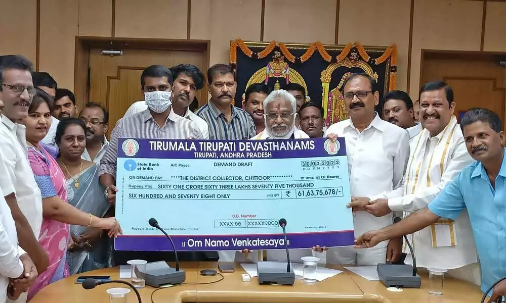 TTD Chairman Y V Subbareddy and MLA B Karunakar Reddy handing over the cheque of Rs 61.63 crore to Collector M Harinarayanan at Padmavathi Rest House in Tirupati on Thursday.