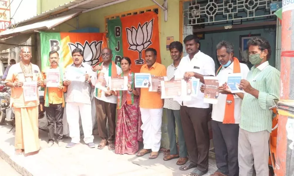 BJP leaders releasing posters of welfare schemes being implemented by the Centre, in Tirupati on Thursday.