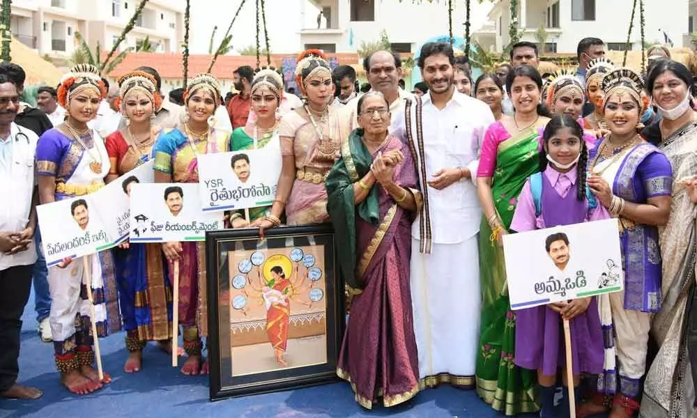 Chief Minister Y S Jagan Mohan Reddy and his wife Bharati with children who presented cultural programmes during Ugadi celebrations at his camp office in Tadepalli on Saturday