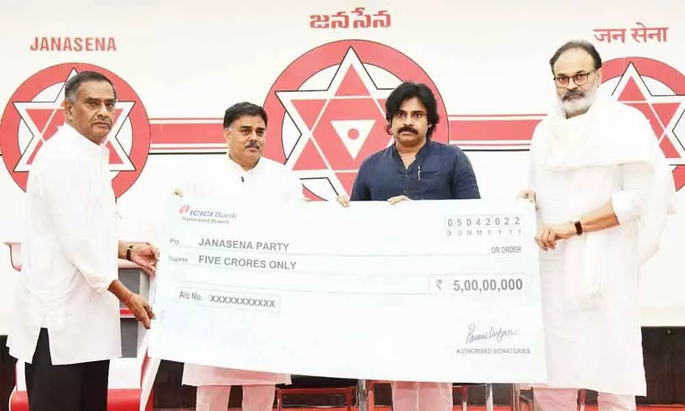 Jana Sena Party chief Pawan Kalyan, Nagababu, Nadendla Manohar release Rs 5 cr cheque for the families of tenant farmers who committed suicide, at party meeting in Mangalagiri on Tuesday