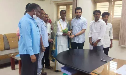 ITDA PO Potru Gautham felicitating Padma Sri awardee Ramachandraiah at the ITDA office in Bhadrachalam on Wednesday