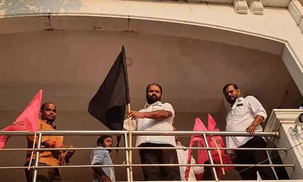 MLA Bhupal Reddy hoisting a black flag at his residence in Nalgonda on Friday