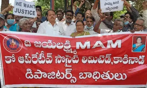 Depositors staging a dharna at Dharna Chowk in Kakinada on Friday, seeking repayment of their money deposited in Jayalakshmi Multipurpose Cooperative Society