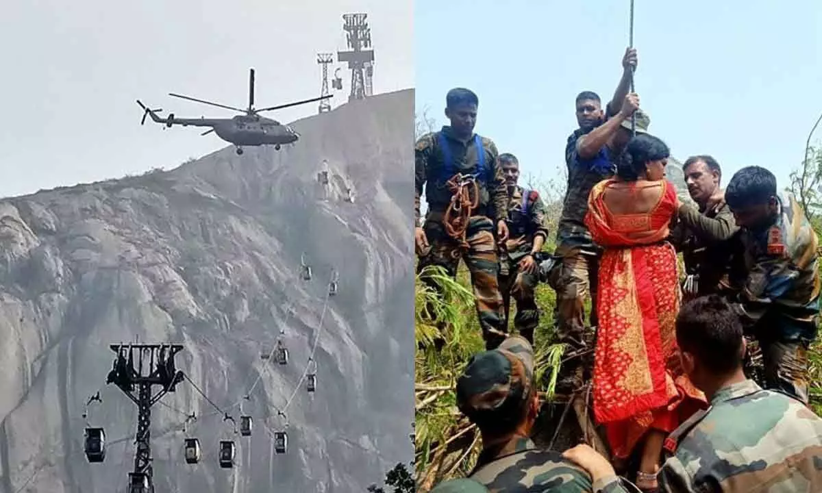Paramilitary personnel rescue a woman during an operation carried out by Indo-Tibetan Border Police and National Disaster Response Force personnel, where the ropeway trolley accident took place, near Trikut, in Deoghar