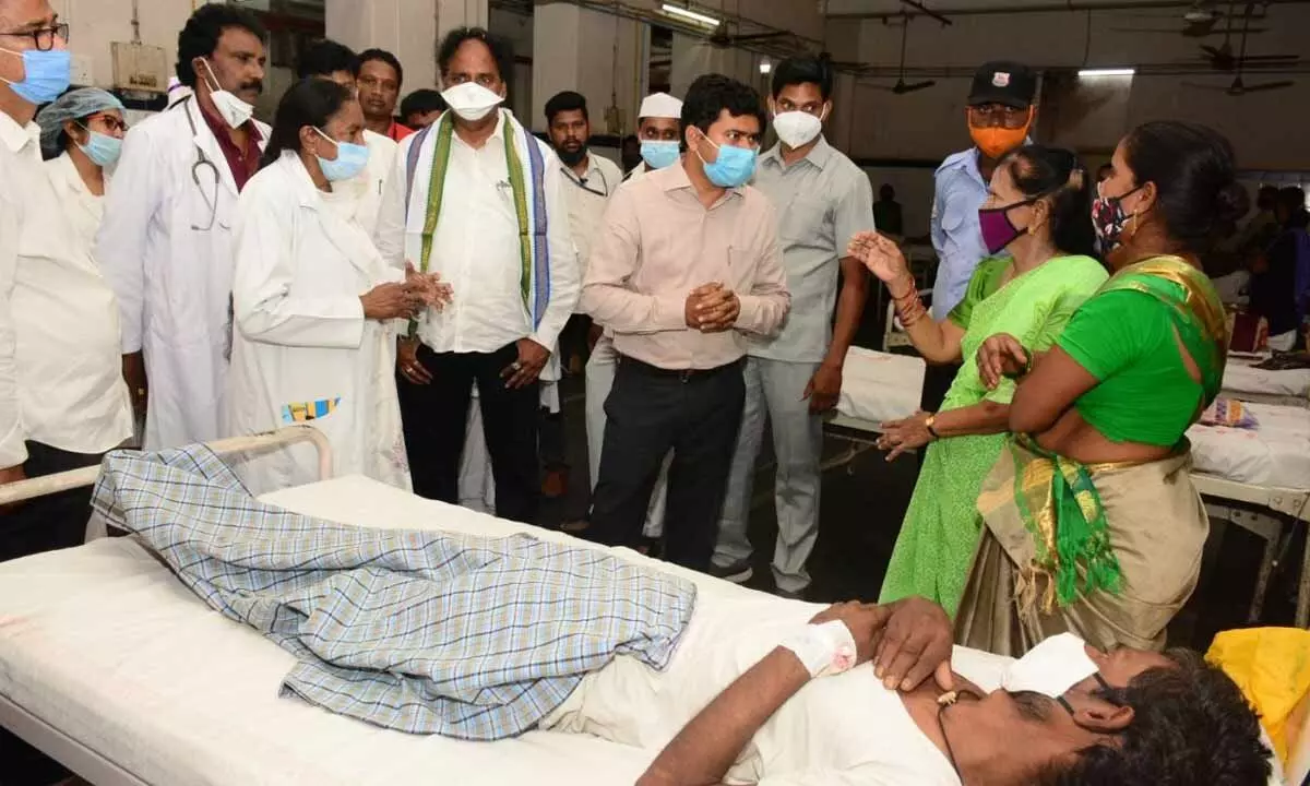 District Collector A Mallikarjuna interacting with the patients at KGH in Visakhapatnam on Tuesday