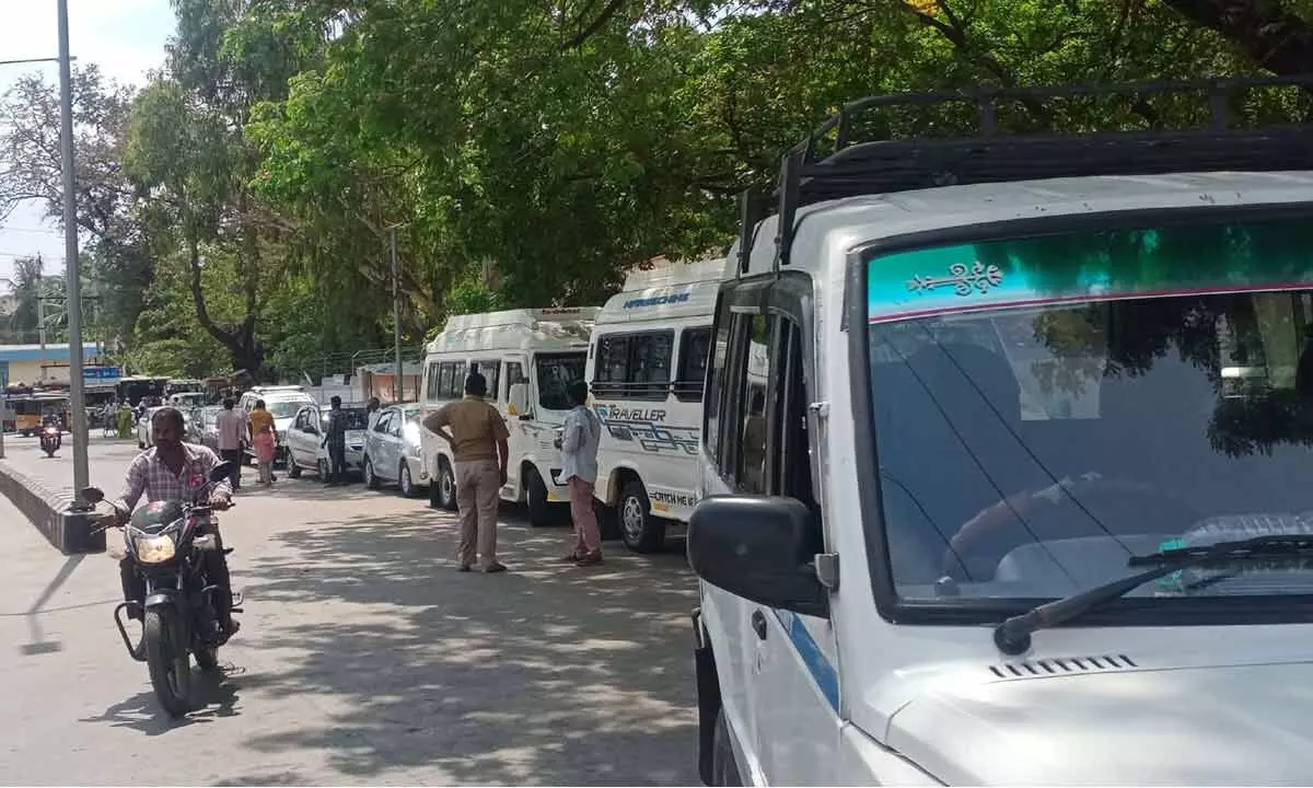 Pilgrim vehicles parked on the roadside near the bus stand in Tiruchanur
