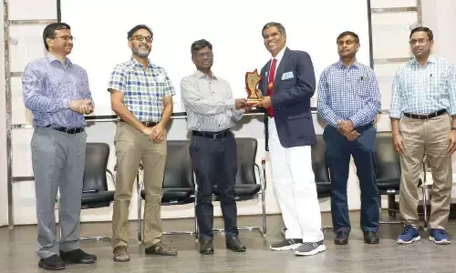Principal Chief Commercial Manager G John Prasad giving prize to a ticket checking officer at Rail Nilayam in Secunderabad