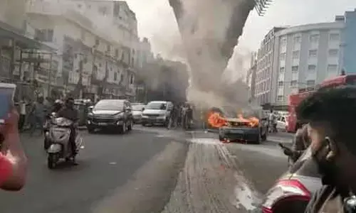 Moving car catches fire