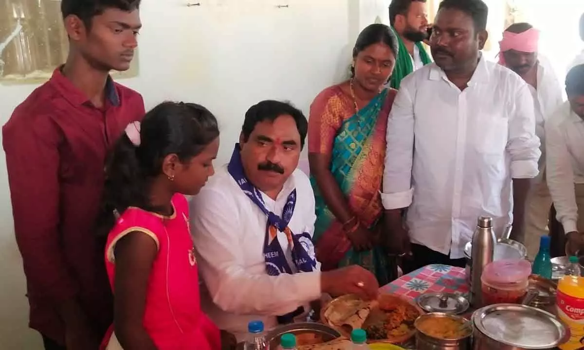 Minister for Panchayat Raj and Rural Development Errabelli Dayakar Rao having lunch at a Dalits residence at Chinna Madur village in Jangaon district on Thursday