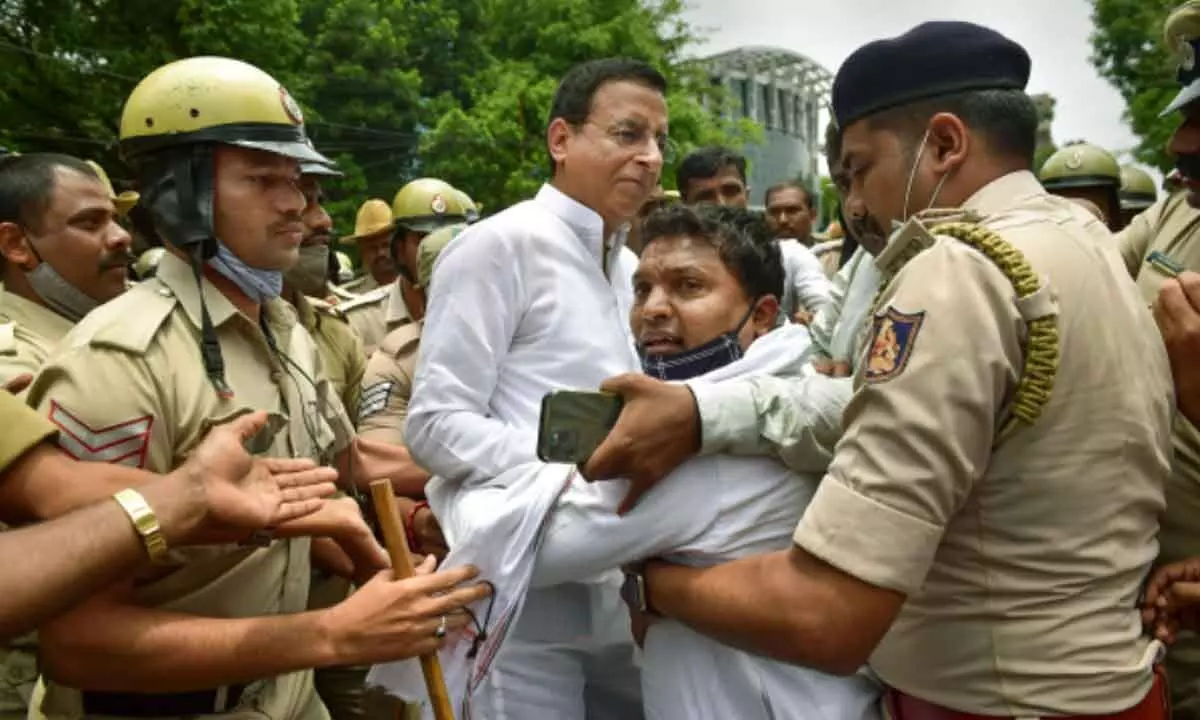 Congress leader and General Secretary in-charge of Karnataka RandeepSurjewalaand IYC president B V Srinivas being detained by police during a protest rally demanding the removal of K.S.Eshwarappa from the cabinet, in Bengaluru, Thursday