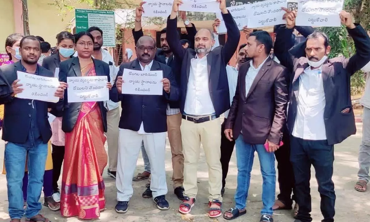 Lawers stage a protest at Court Complex in Nellore against the theft in court, in Nellore on Saturday