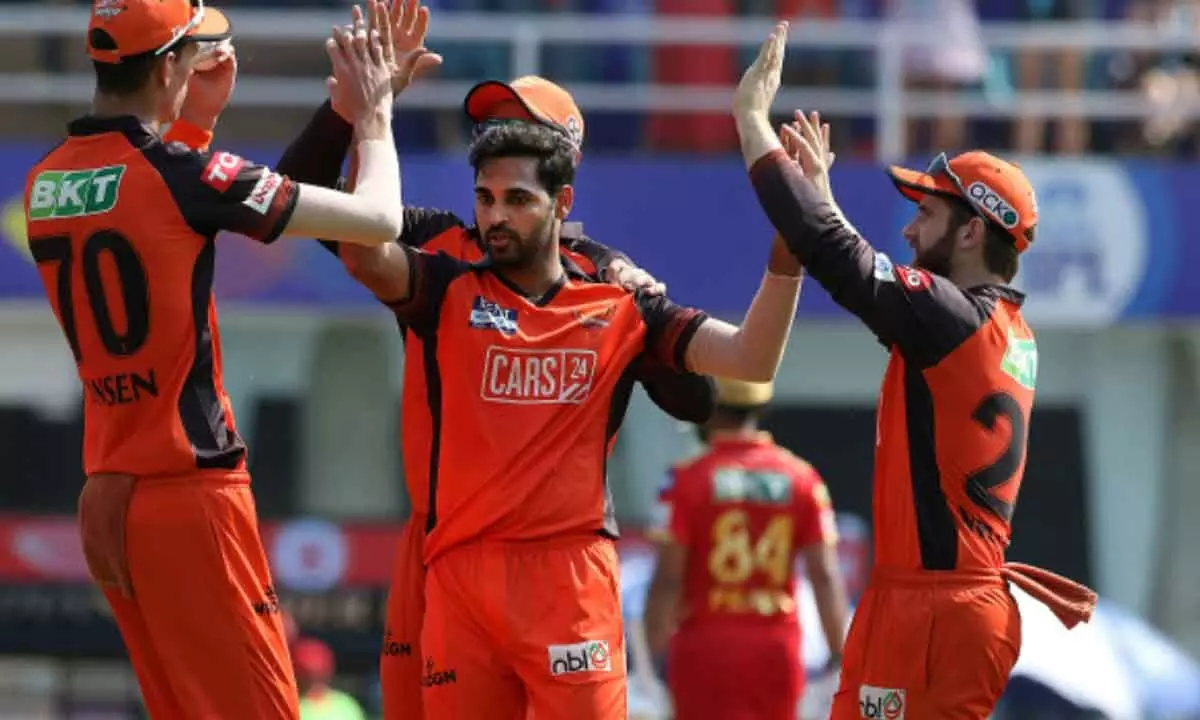 Bhuvneshwar Kumar of SRH celebrates with teammates after the wicket of Shikhar Dhawan, captain of Punjab Kings, during the IPL match at the DY Patil Stadium, in Mumbai on Sunday