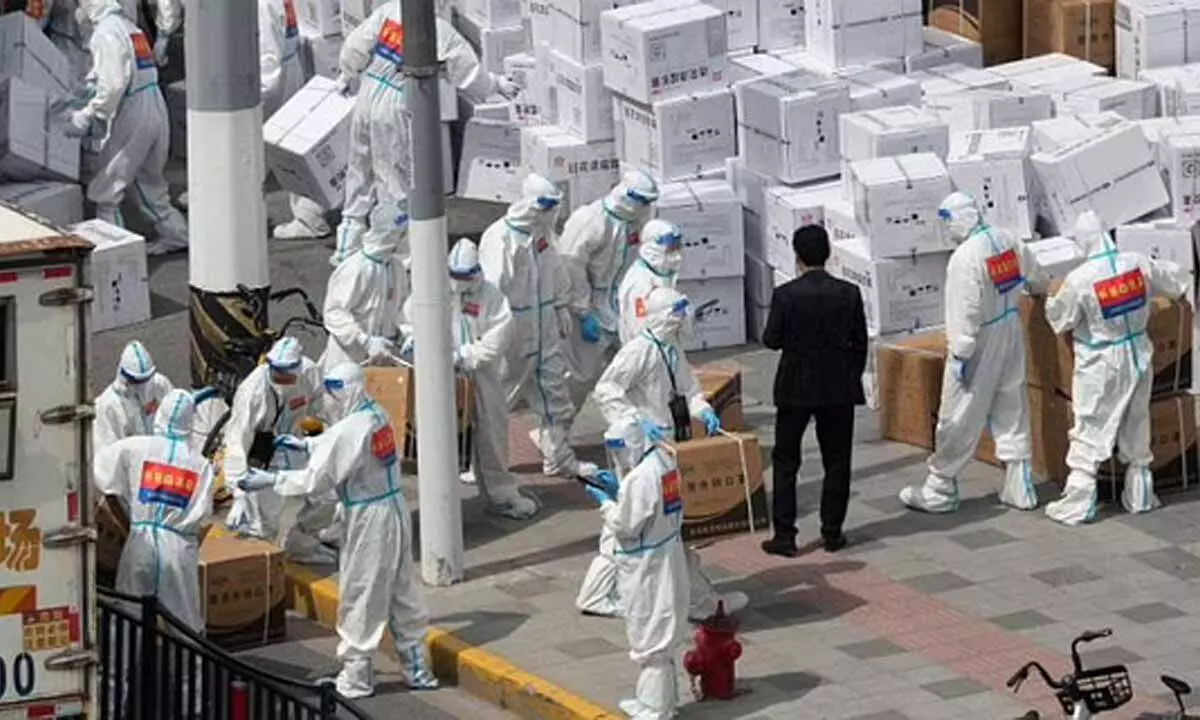 Workers unload supplies including boxes of masks in Shanghai. (Photo| AP)