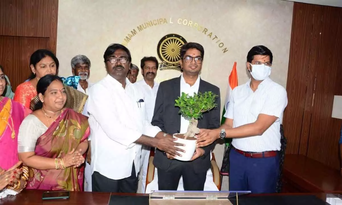 Minister for Transport P Ajay Kumar felicitating Municipal Commissioner Anand Surabhi at the inauguration of the new KMC  building in Khammam on Monday