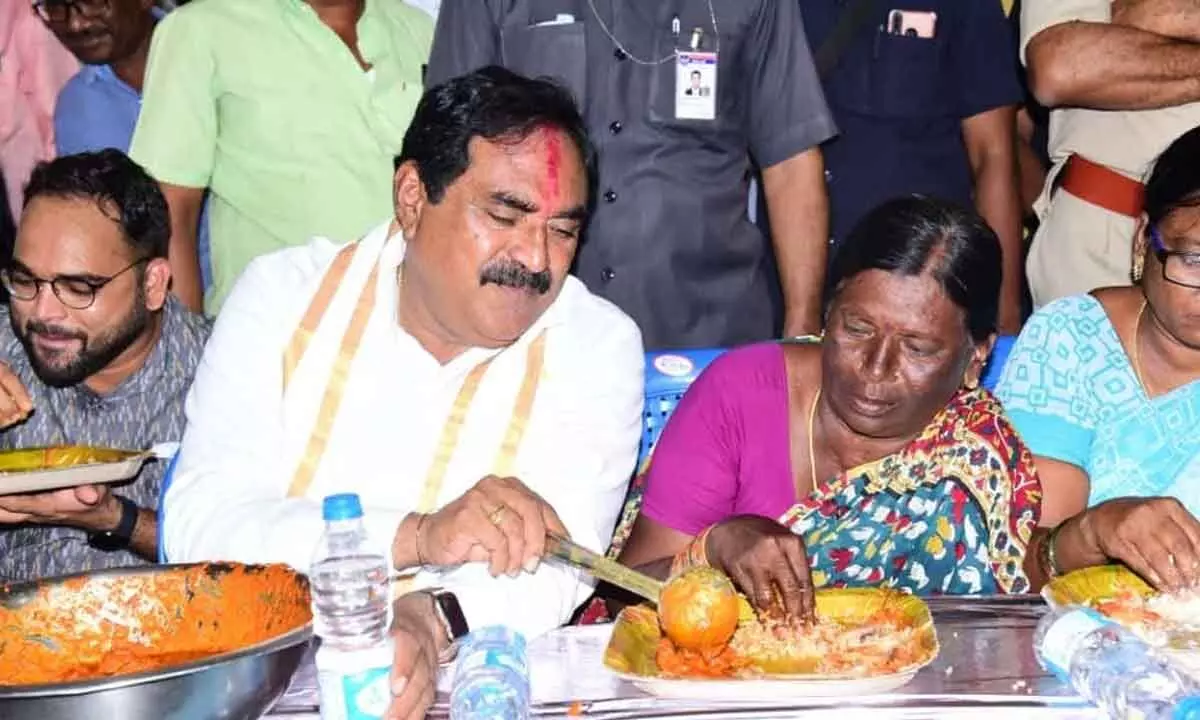 Minister for Panchayat Raj and Rural Development Errabelli Dayakar Rao serving to a woman during assets distribution programme in Mahabubabad on Monday