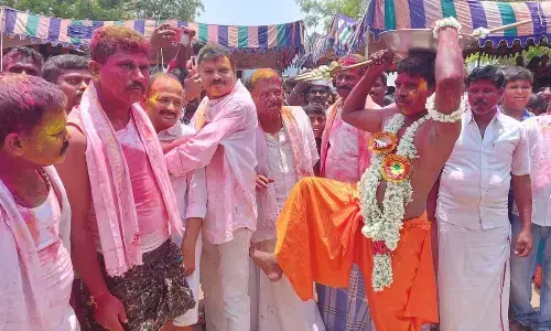 Priest Veerabhadra Swamy kicking devotees at Sri Sidda Rameshwara Swamy temple at Chinna Hotour village in Aspari mandal in Kurnool district on Monday