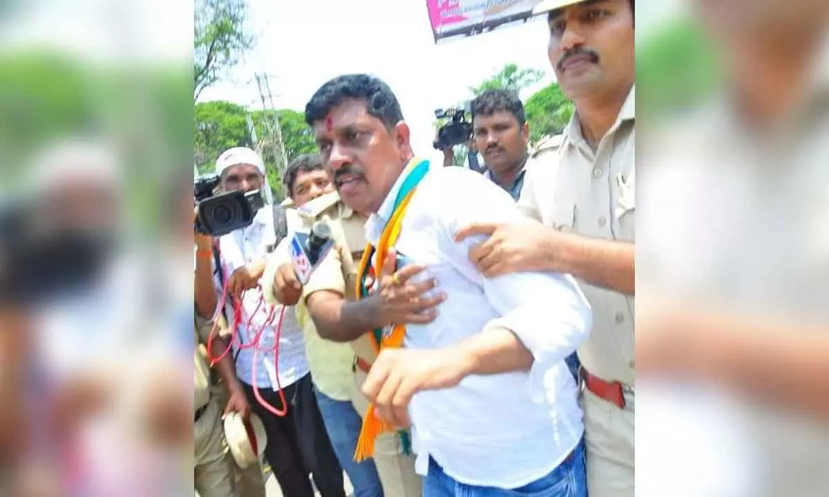The police arresting BJP  district president Galla Satyanarayana in Khammam on Wednesday