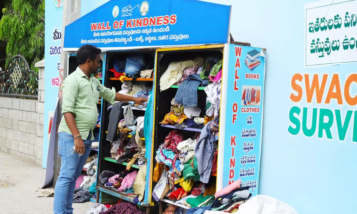 A resident keeping some clothes at the Wall of Kindness in front of municipal corporation office in  Tirupati on Saturday