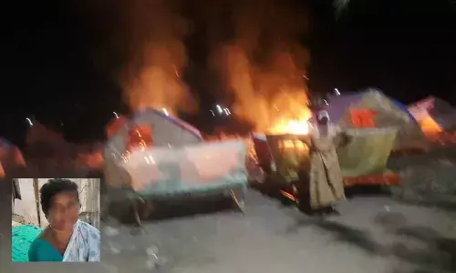 Houses going up in flames at Arundathi Nagar in Kurnool on Monday. ; R Lakshmi, a resident and victim of Arundathi Nagar (Inset Pic)