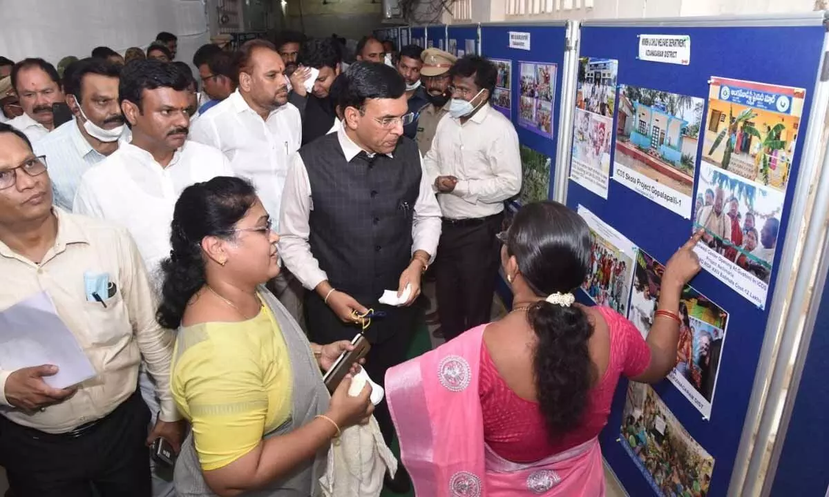 Union Minister Mansukh Mandaviya watches a photo exhibition organised at the collectorate in Vizianagaram on Tuesday