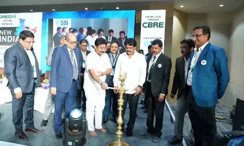 AP Urban Development Minister Audimulapu Suresh lighting the lamp