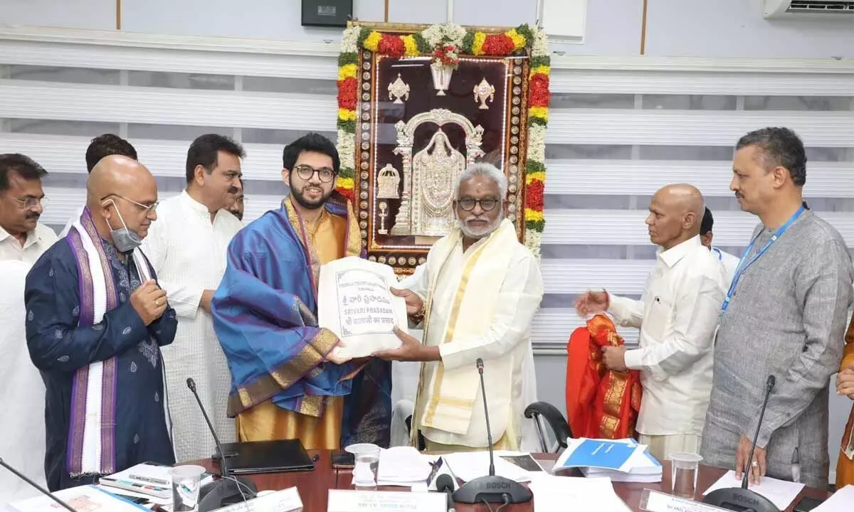 Maharashtra Tourism Minister Aditya Thackeray handing over the documents of the land worth Rs 500 crore donated to TTD for construction of a temple in Navi Mumbai, to TTD Chairman YV Subba Reddy at Tirumala on Saturday. TTD EO K S Jawahar Reddy and others are seen.