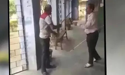 Principal, peon attack  each other with sticks