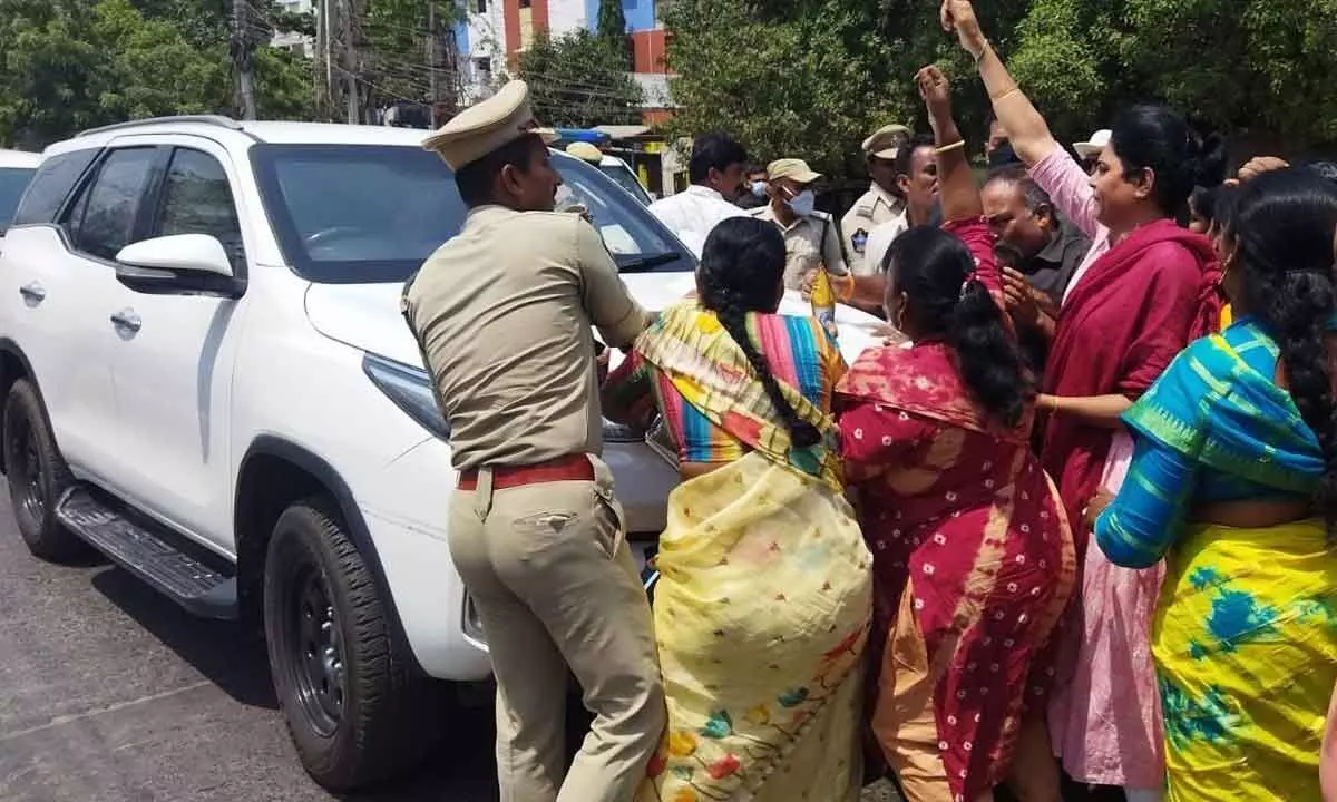 TDP women workers trying to gherao Home Minister Taneti Vanitha on her tour to Ongole on Monday