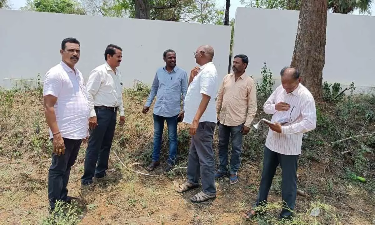 Tribal welfare department executive engineer DVRM Raju and other officials on the premises of Alluri Sitarama Raju Memorial Hall in Rajendrapalem in ASR district on Monday