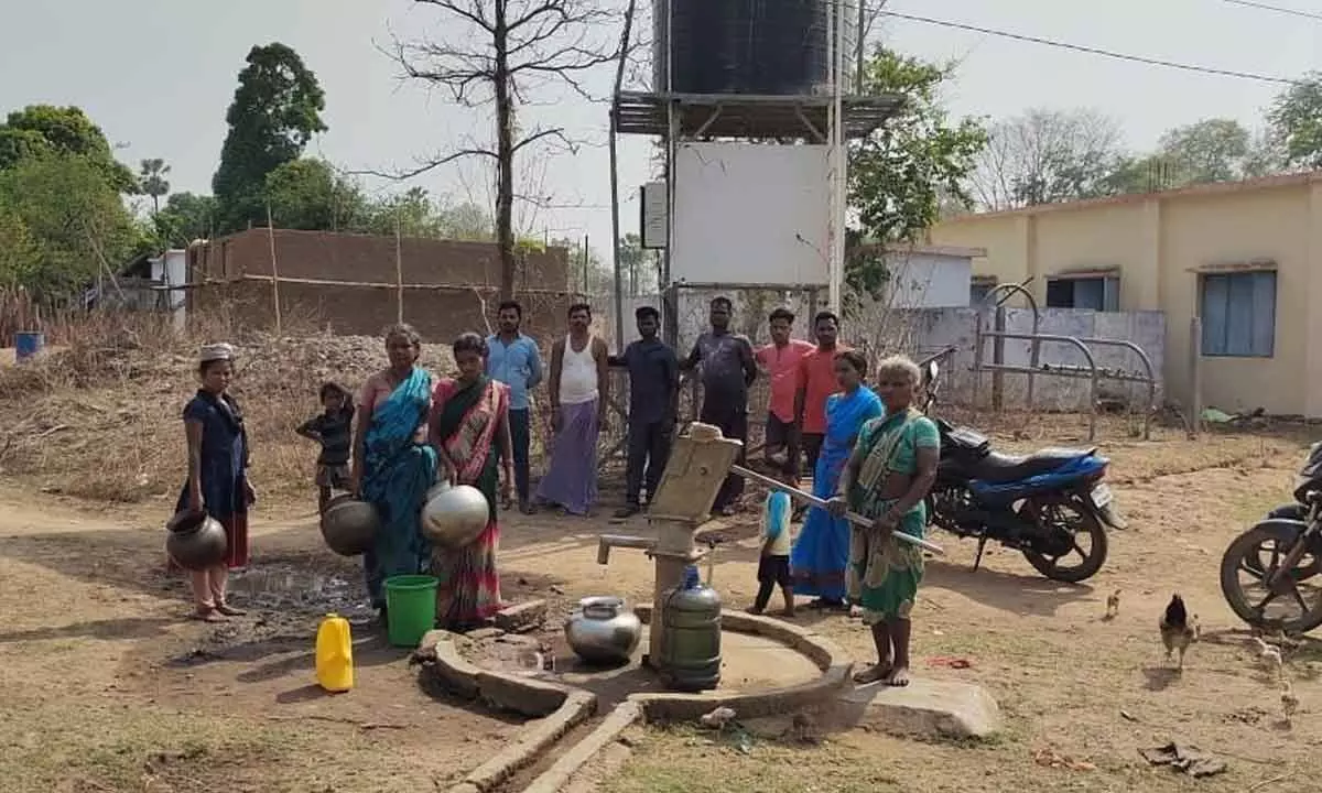 A group of tribals waiting for drinking water at a hand pump in Adavi Ramavaram.