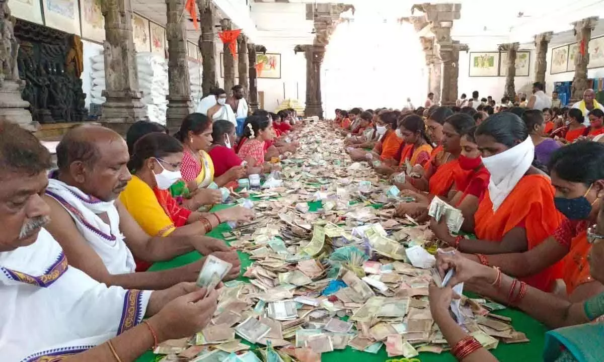 Officials and volunteers counting hundi income at Chintrakuta Mandapam on Lord Rama temple premises in Bhadrachalam on Monday.