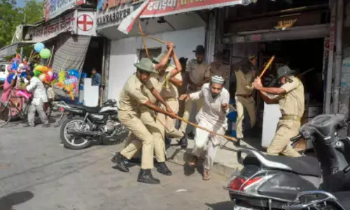 Police baton-charge a protester after clashes broke out in Jalori Gate area, in Jodhpur on Tuesday