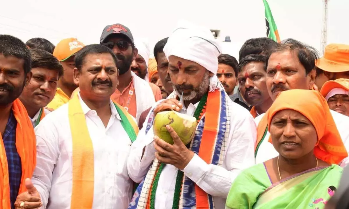 Bandi Sipping coconut water to beat the heat in Mahbubnagar on Wednesday