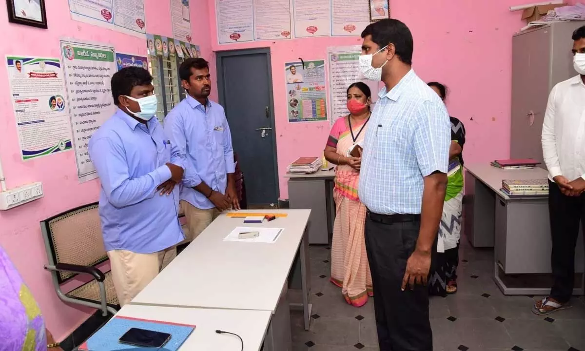 District Collector M Hari Narayanan interacting with the staff of Grama sachivalayam at Thimmarajapuram in Palasamudram mandal on Wednesday