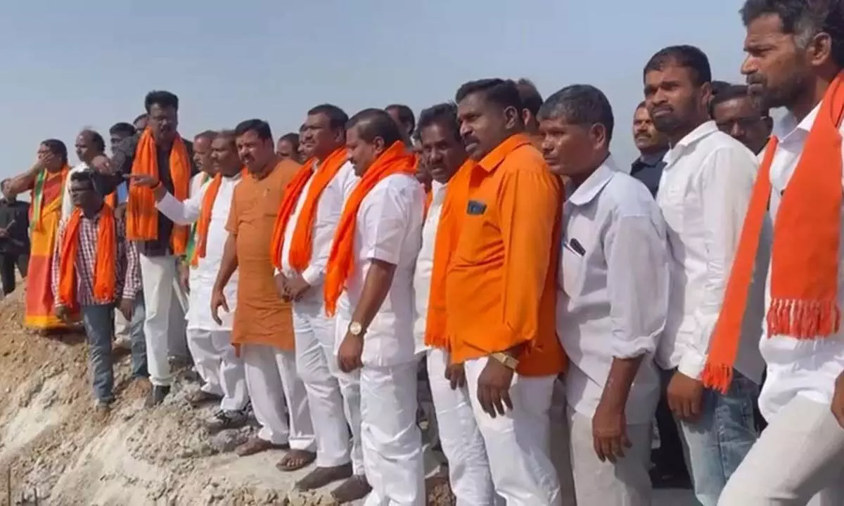 BJP leader Raja Singh along with party leaders inspecting the damaged roads at Yadadri